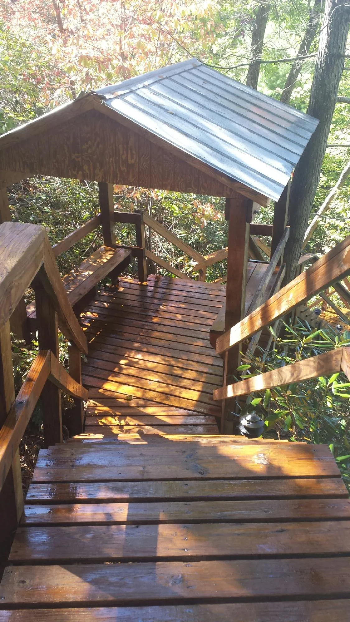 Freshly stained wood walkway and covered shelter with a metal roof in Robertsville